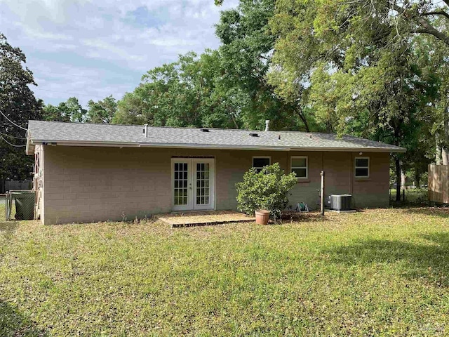 925 Artesian Ave, Pensacola, FL 32505 - rear view of house featuring french doors, a lawn, central AC, fence, and concrete block siding