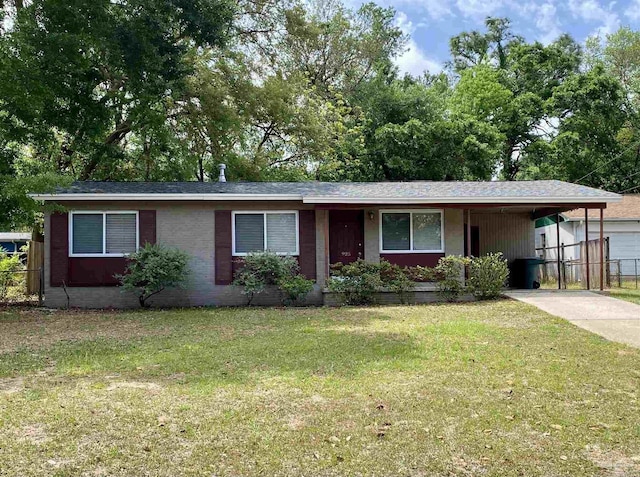 925 Artesian Ave, Pensacola, FL 32505 - single story home with concrete driveway, fence, a front yard, and a carport