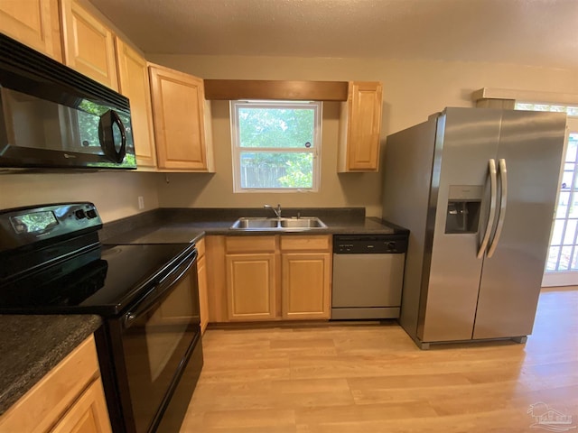 925 Artesian Ave, Pensacola, FL 32505 - kitchen featuring a healthy amount of sunlight, a sink, black appliances, and light wood-style floors