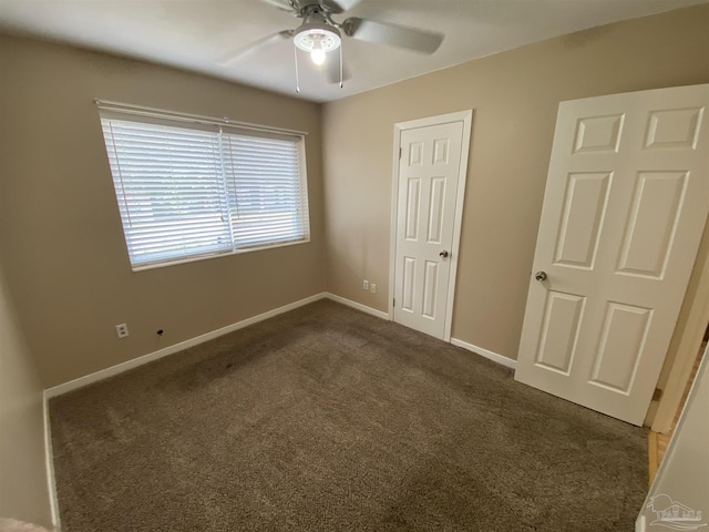 925 Artesian Ave, Pensacola, FL 32505 - unfurnished bedroom featuring dark colored carpet, a ceiling fan, and baseboards