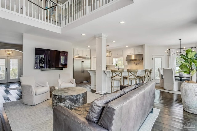 living room featuring french doors, hardwood / wood-style flooring, and plenty of natural light