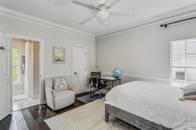 bedroom featuring dark hardwood / wood-style floors, ceiling fan, and ornamental molding