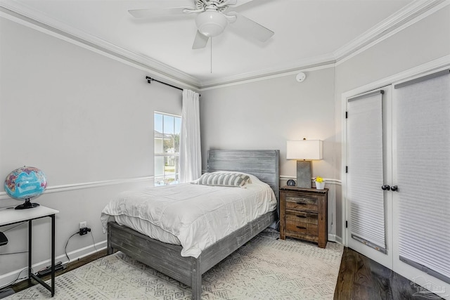 bedroom with light hardwood / wood-style floors, ceiling fan, and ornamental molding