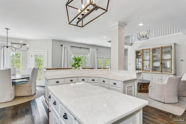 kitchen with a center island, white cabinets, and an inviting chandelier