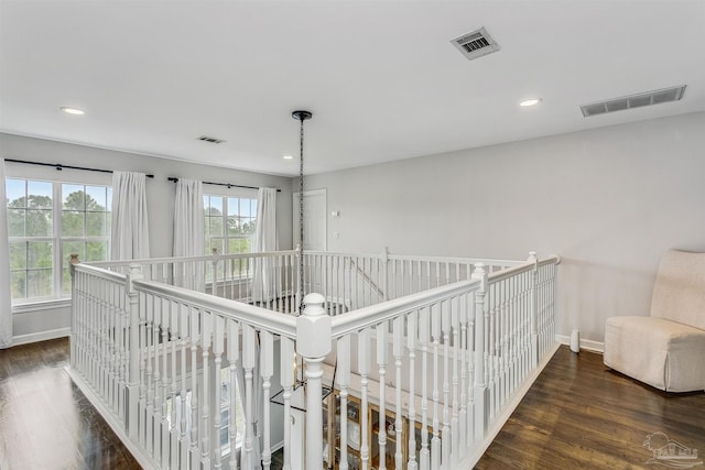 corridor with dark hardwood / wood-style floors