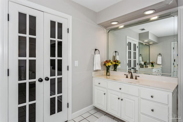 bathroom featuring tile patterned flooring, vanity, and french doors