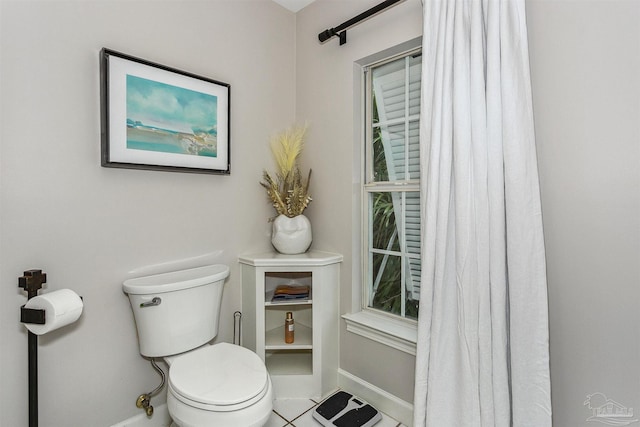 bathroom with tile patterned flooring and toilet