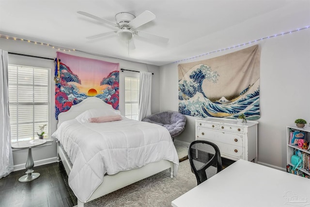 bedroom with ceiling fan, dark wood-type flooring, and multiple windows