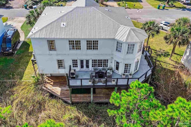 back of house with french doors and a wooden deck