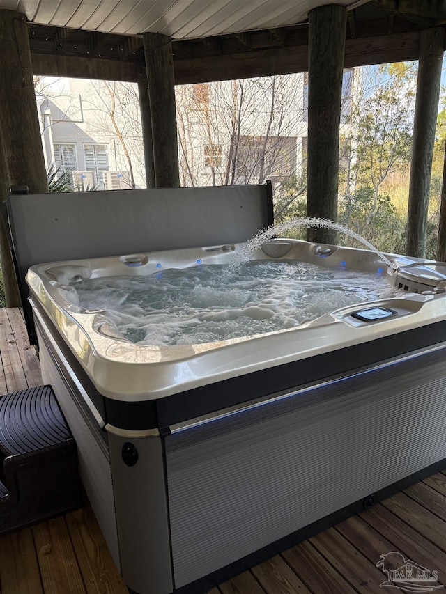 wooden terrace with a hot tub