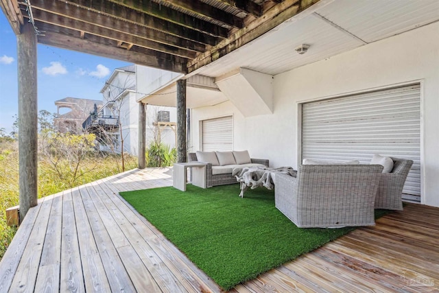 wooden terrace featuring outdoor lounge area and a yard