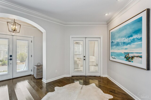 doorway with dark hardwood / wood-style flooring, french doors, and an inviting chandelier