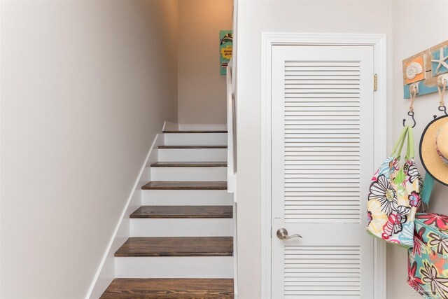 staircase with wood-type flooring