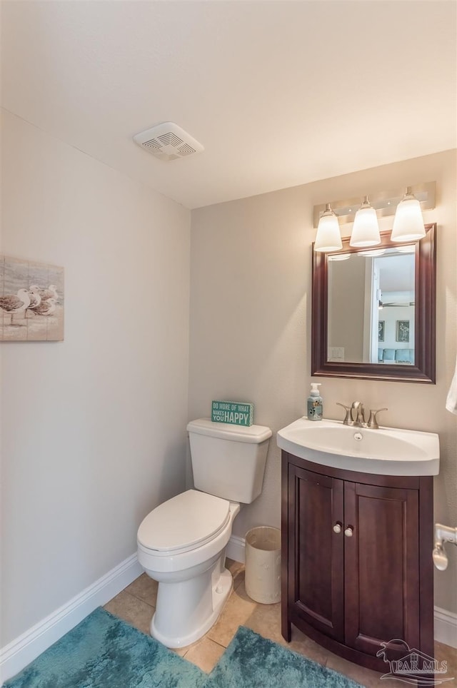 bathroom with tile patterned floors, vanity, and toilet