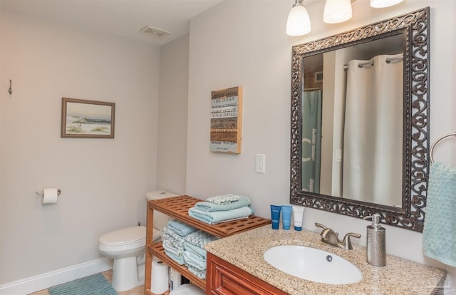 bathroom with tile patterned floors, vanity, and toilet