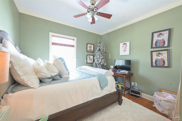 bedroom with crown molding, hardwood / wood-style floors, and ceiling fan