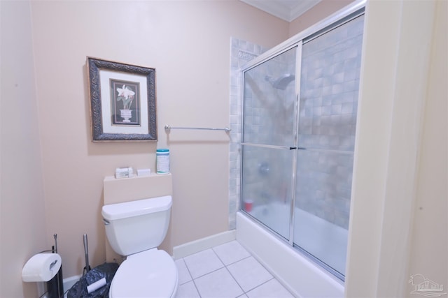 bathroom with tile patterned flooring, ornamental molding, enclosed tub / shower combo, and toilet