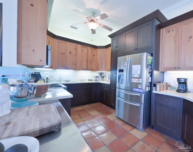 kitchen featuring light tile patterned floors, light countertops, ornamental molding, ceiling fan, and stainless steel fridge with ice dispenser