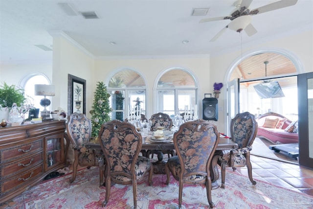 dining area with ornamental molding and ceiling fan