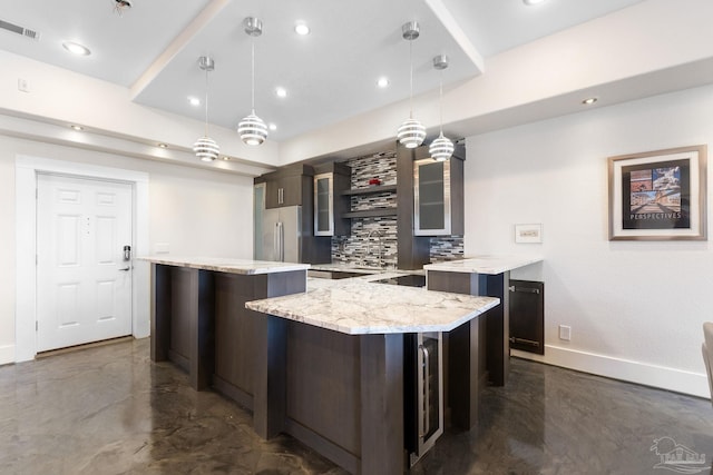 999 Ft Pickens Rd Unit 309, Pensacola Beach, FL 32561 - kitchen featuring decorative light fixtures, light stone countertops, a center island, and decorative backsplash