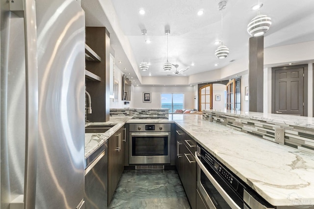999 Ft Pickens Rd Unit 309, Pensacola Beach, FL 32561 - kitchen featuring sink, tasteful backsplash, hanging light fixtures, appliances with stainless steel finishes, and light stone countertops