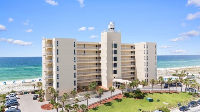 view of property featuring a view of the beach and a water view