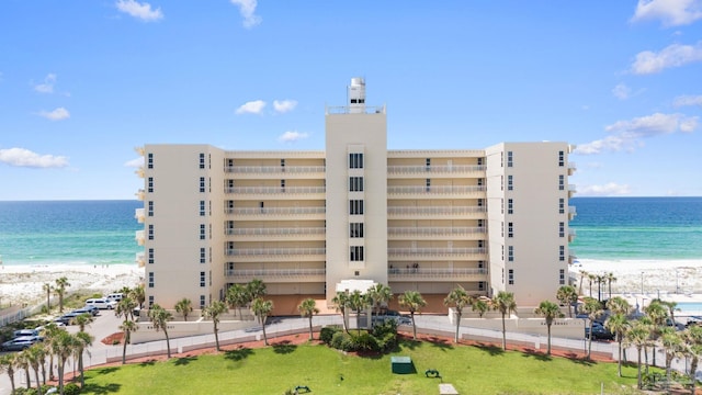 view of building exterior featuring a view of the beach and a water view