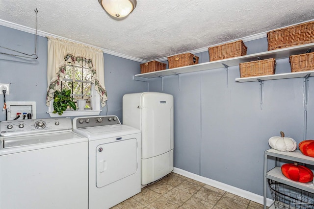 washroom featuring a textured ceiling, separate washer and dryer, and crown molding