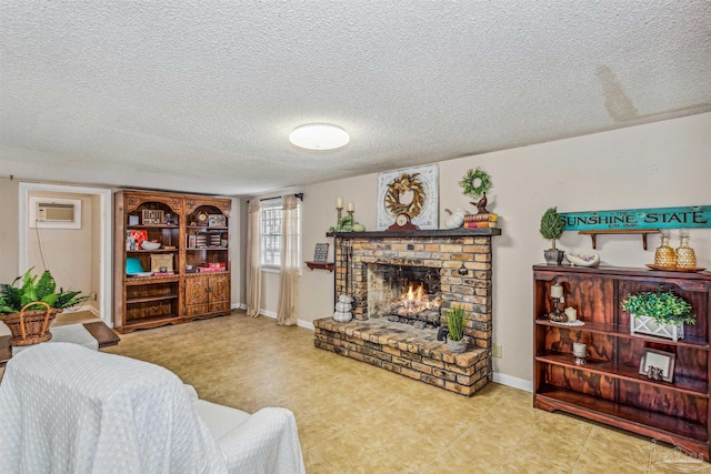 living room featuring a wall mounted air conditioner, a textured ceiling, and a brick fireplace