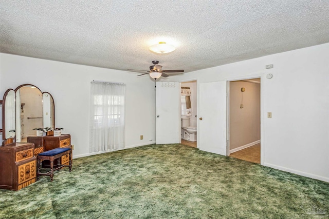 interior space with ensuite bathroom, ceiling fan, and a textured ceiling