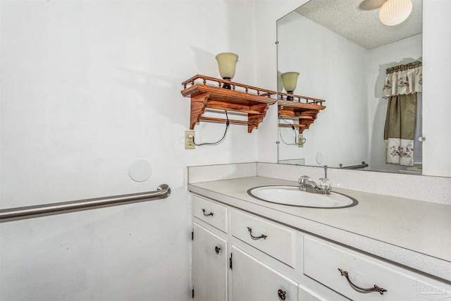 bathroom with vanity and a textured ceiling