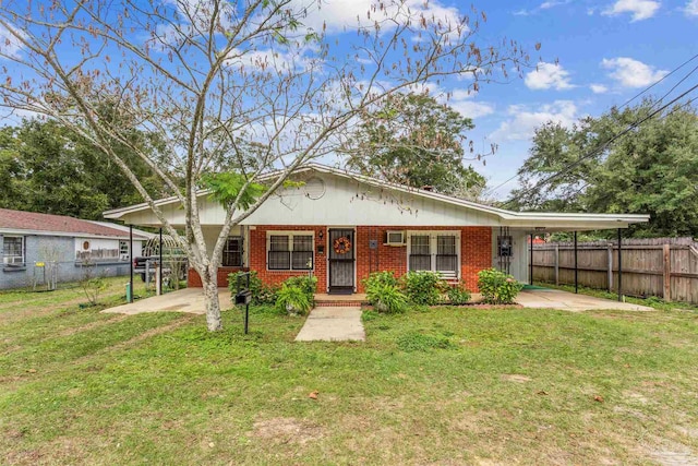 view of front of house featuring a front lawn and a carport