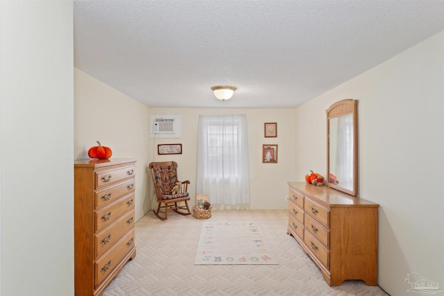 living area featuring light colored carpet and a textured ceiling