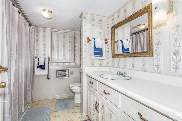 bathroom featuring vanity, toilet, and a textured ceiling