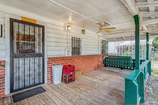 wooden deck with ceiling fan and a porch