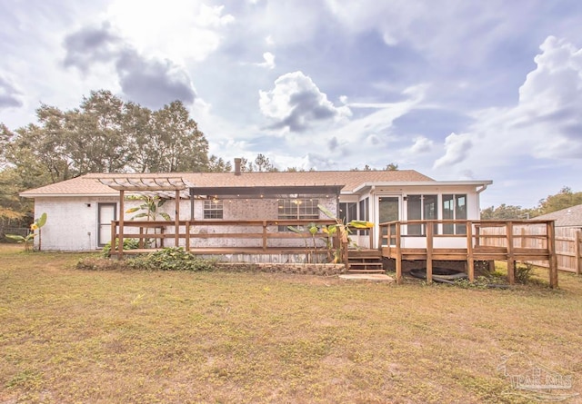 back of house with a deck, a yard, a sunroom, and a pergola