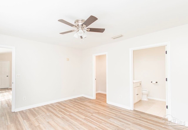 unfurnished bedroom featuring light hardwood / wood-style floors, ensuite bathroom, and ceiling fan