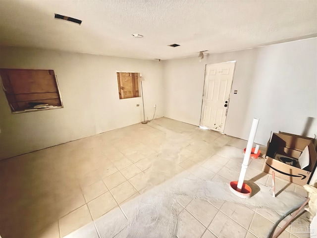 interior space with a textured ceiling