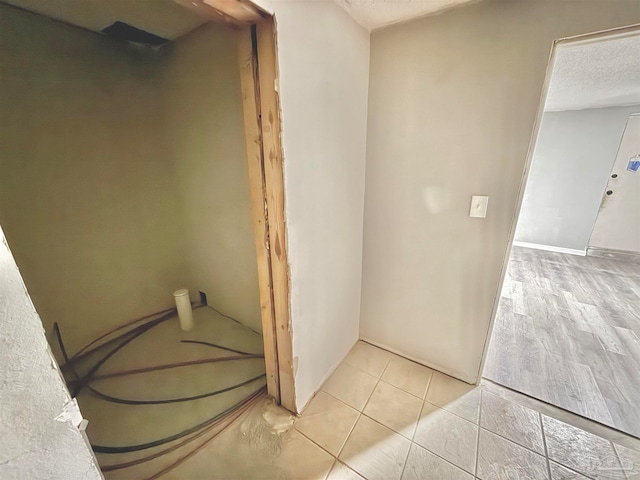 bathroom with a textured ceiling and wood-type flooring