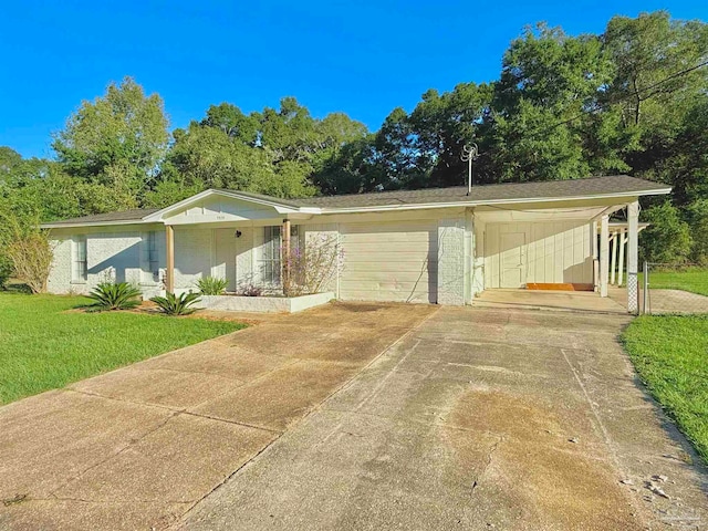 view of front of property with a garage, a front lawn, and a carport