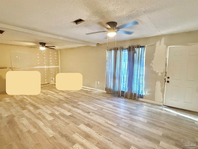 interior space featuring a textured ceiling, wood-type flooring, and ceiling fan