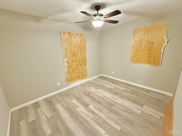 unfurnished room featuring a textured ceiling, ceiling fan, and hardwood / wood-style flooring