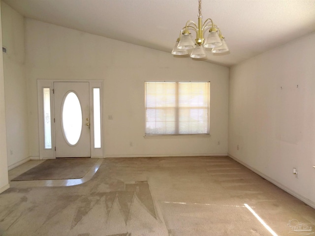 carpeted entrance foyer featuring vaulted ceiling and a notable chandelier