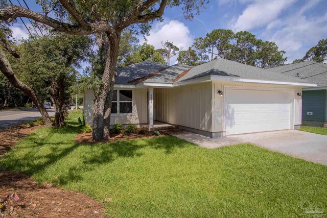 ranch-style home featuring a garage and a front yard