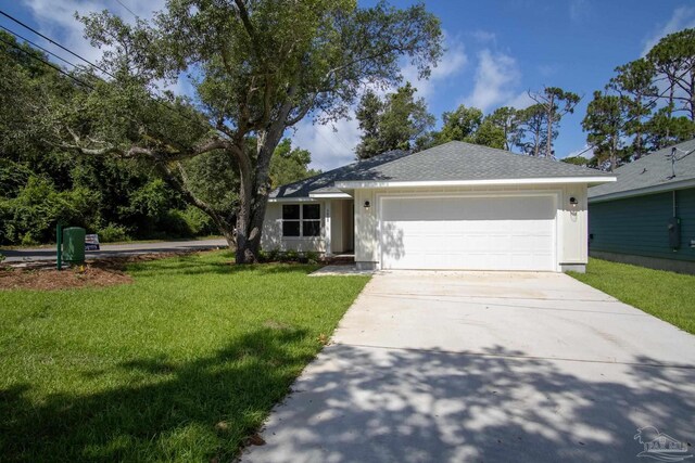 ranch-style home featuring a garage and a front yard