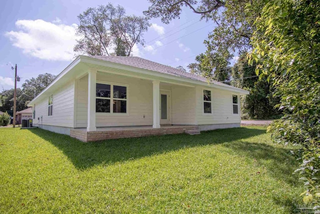 back of house with a yard