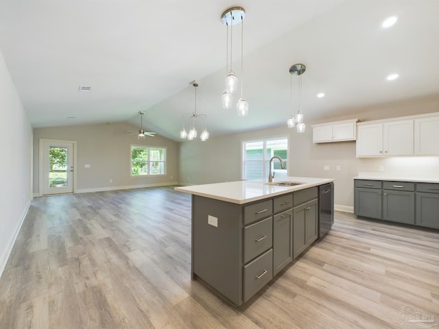 kitchen featuring a sink, white cabinetry, open floor plan, light countertops, and black dishwasher