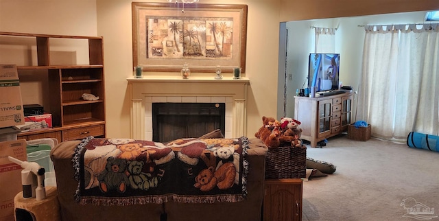 sitting room featuring a tile fireplace and carpet flooring