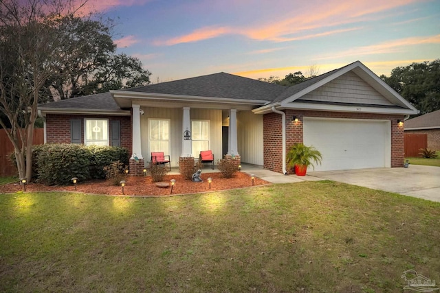 ranch-style house with an attached garage, a front yard, concrete driveway, and brick siding