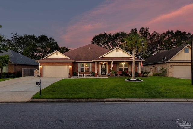 ranch-style house featuring driveway, an attached garage, a front lawn, and brick siding